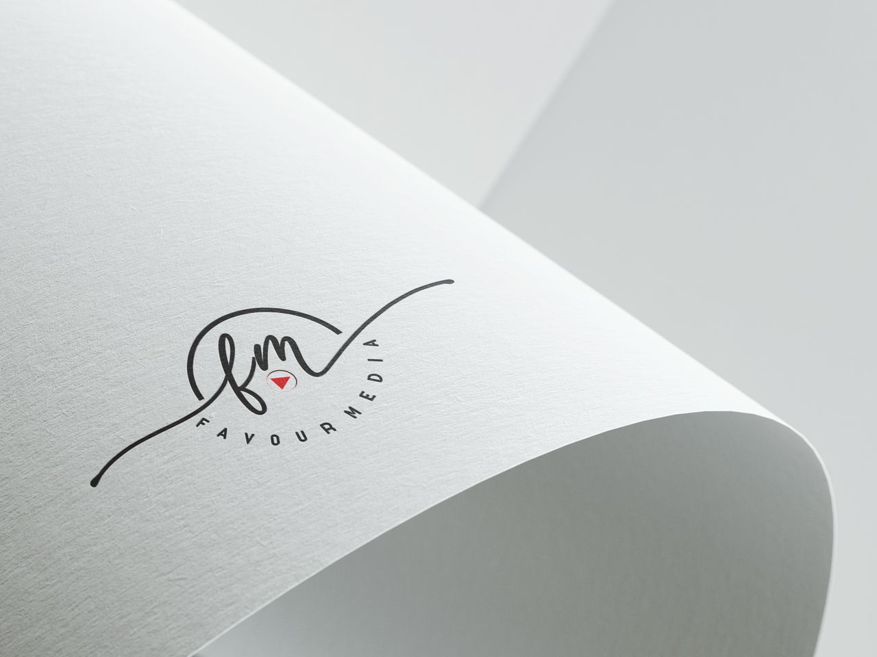 heros-img Minimalist design showcasing Favour Media logo on folded textured paper with copyspace.